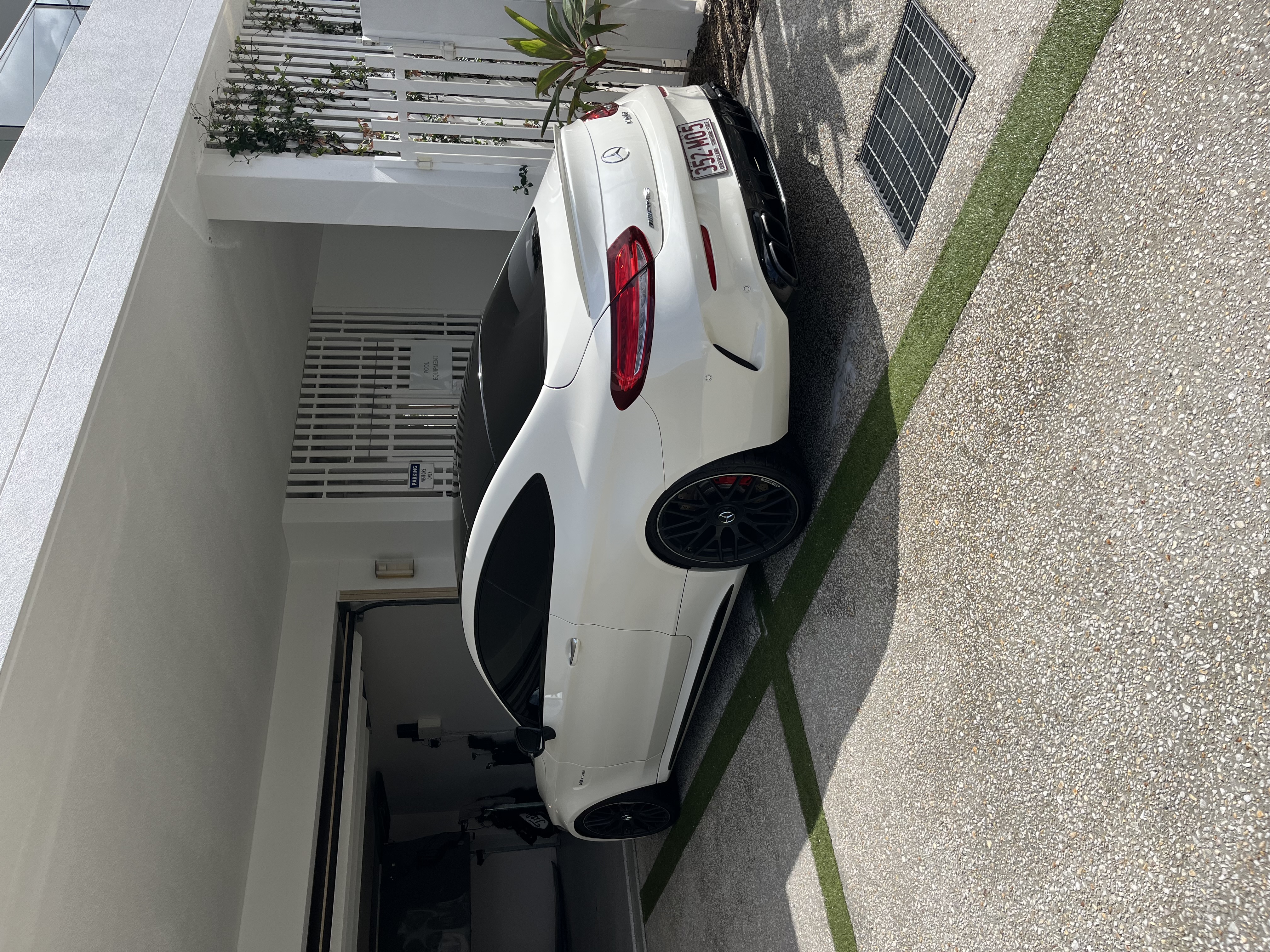 White Mercedes coupe rear exterior after detailing